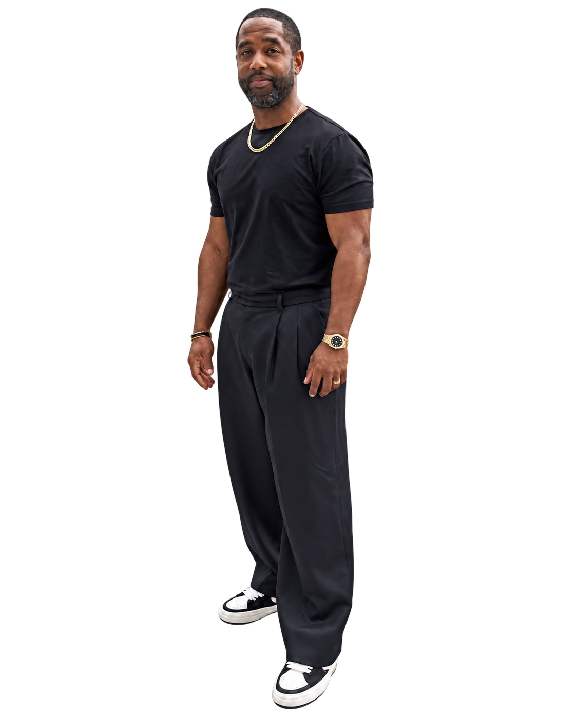 Tony A. Gaskins Jr. standing in a black outfit with gold accents